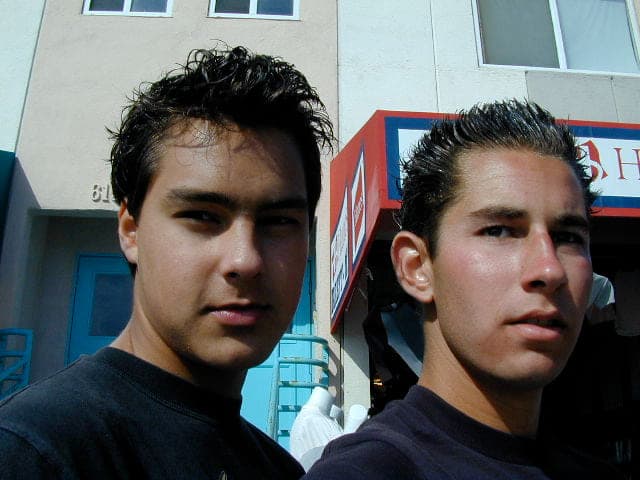Justin as a teenager with a friend, outdoors