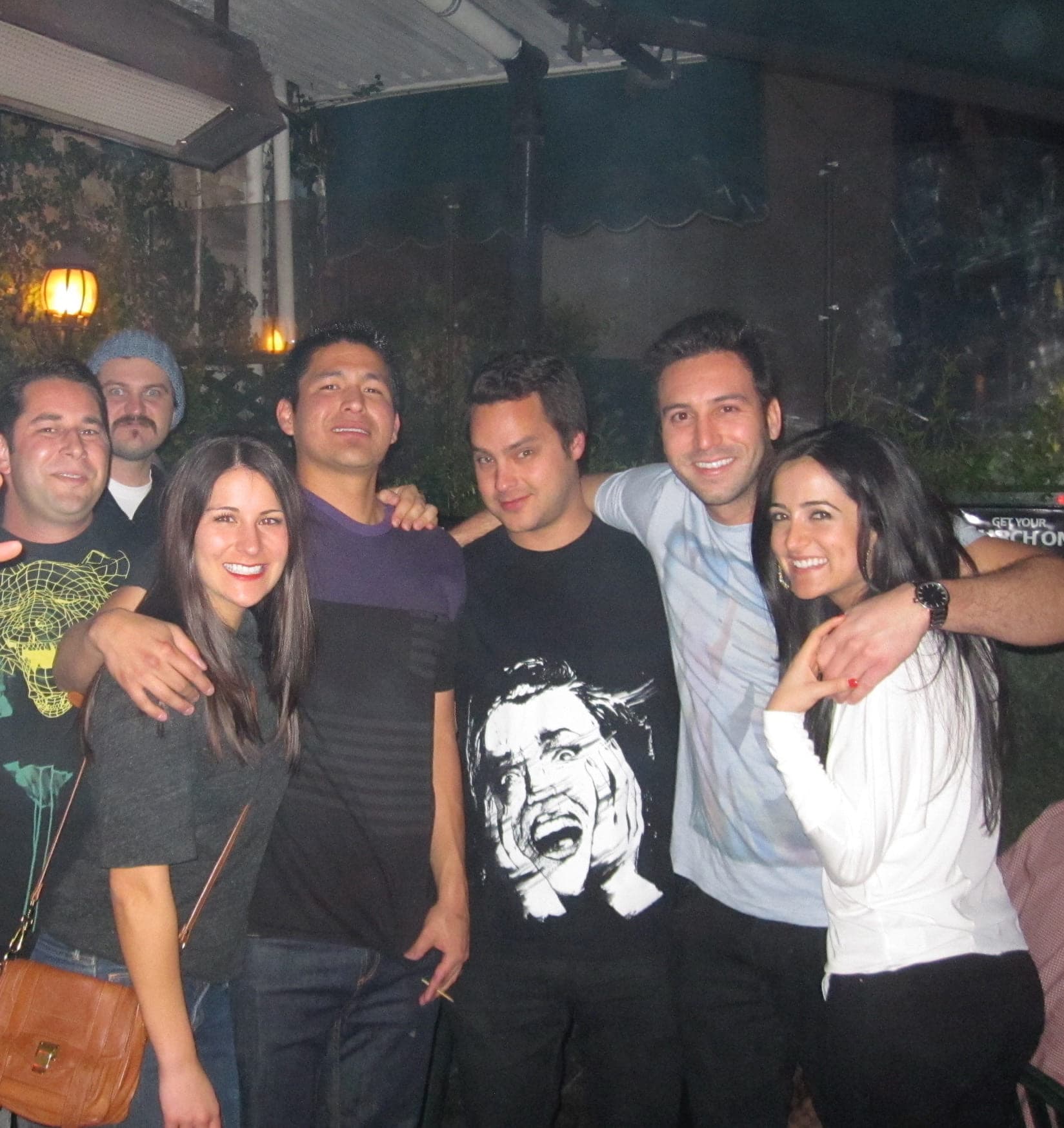 A group of six friends together at an evening gathering