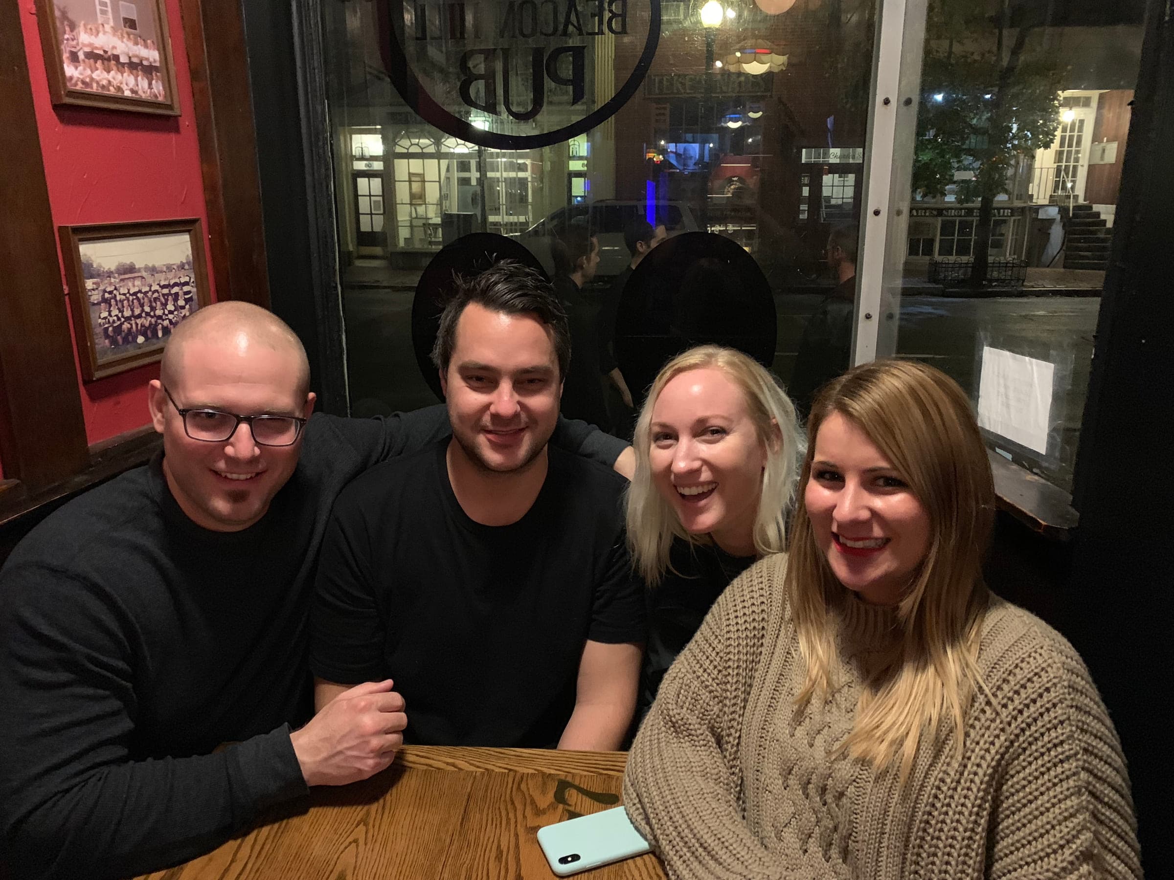Four friends around a table at a pub