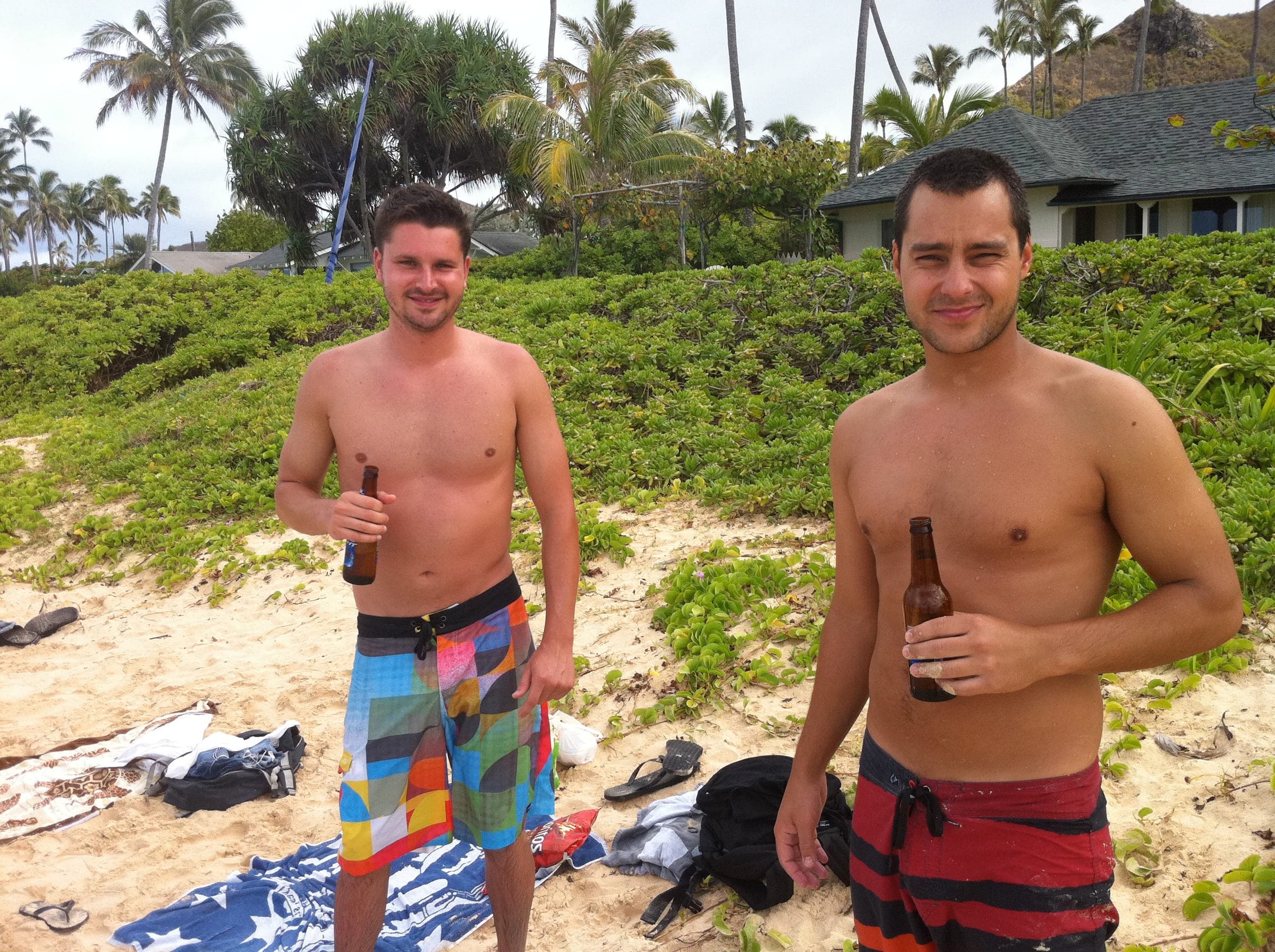 Justin and a friend on the beach with drinks