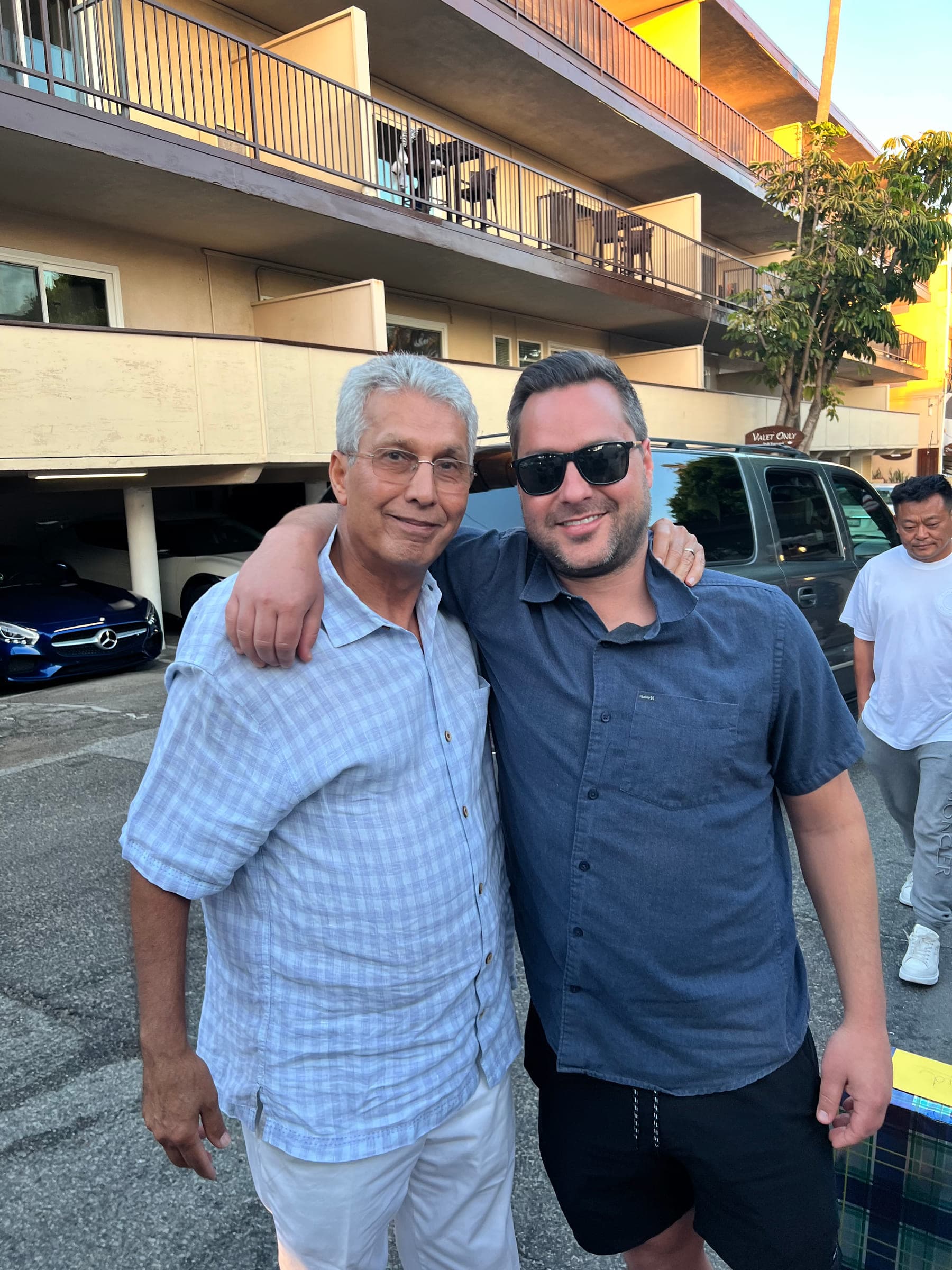 Justin with his father, arms around each other