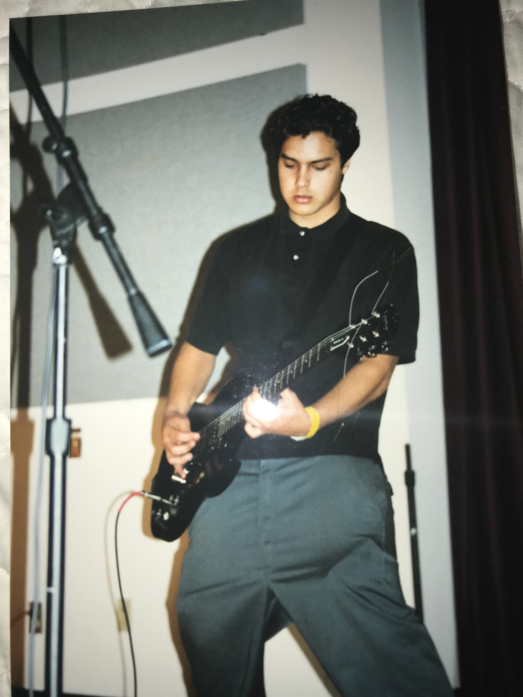 Justin as a young man playing electric guitar