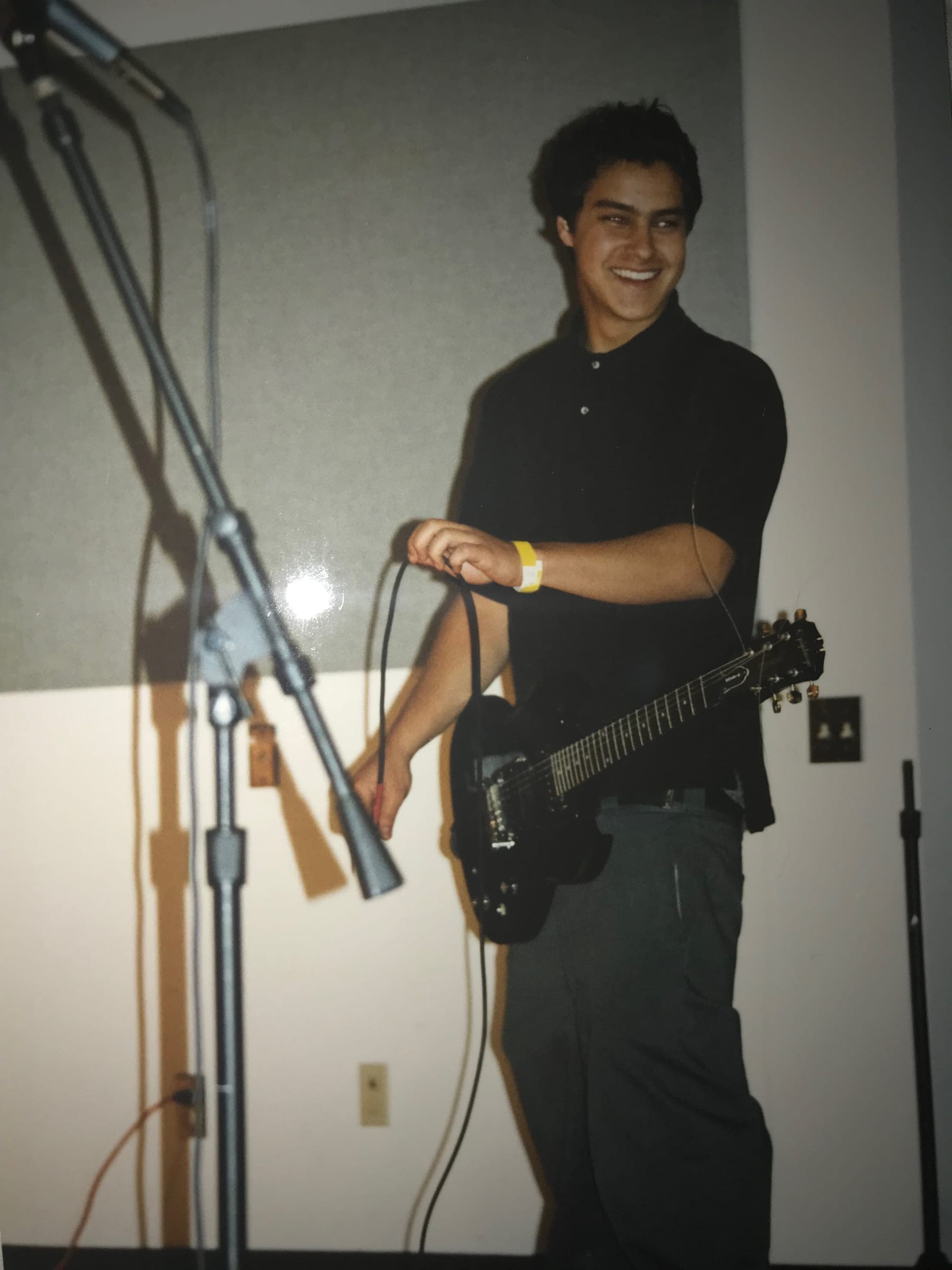 Justin playing electric guitar, mid-song