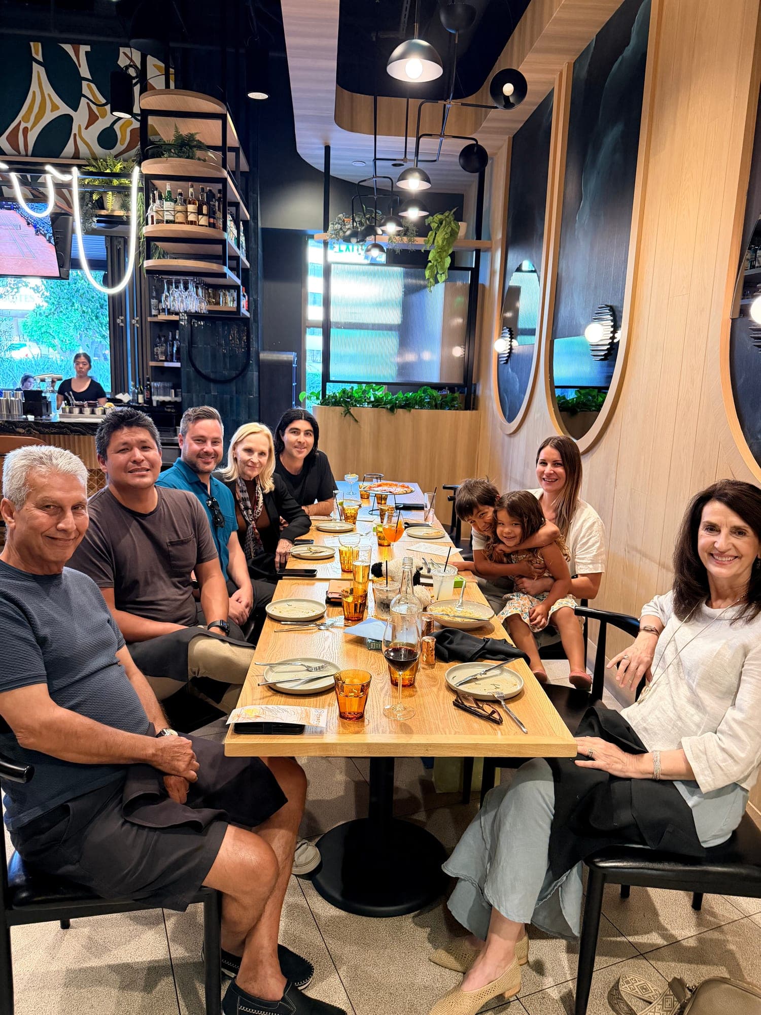 Justin with his family around a long table at dinner
